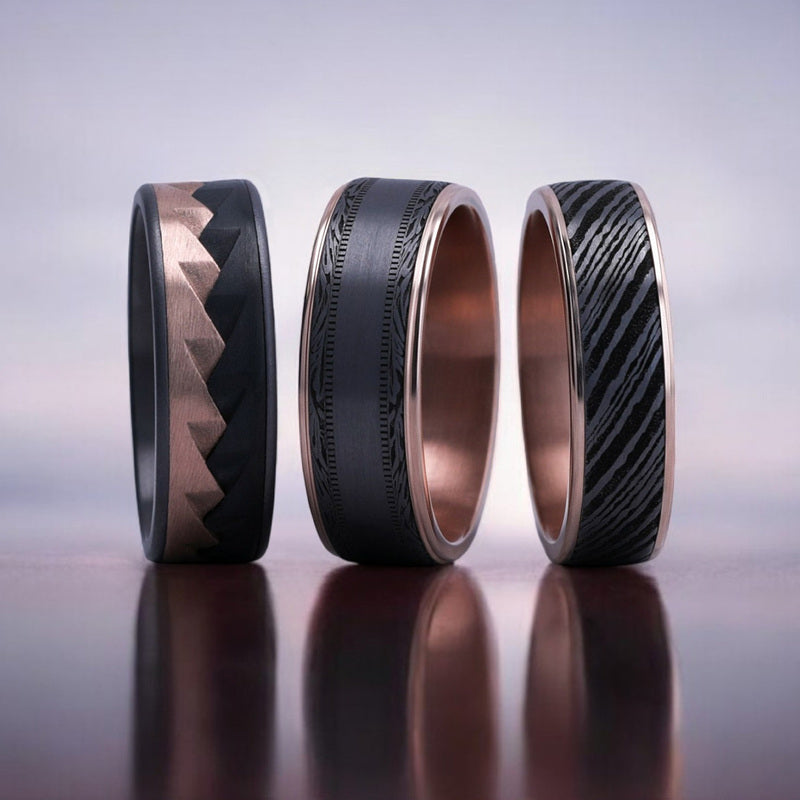 Image of three mens wedding bands in rose gold and black