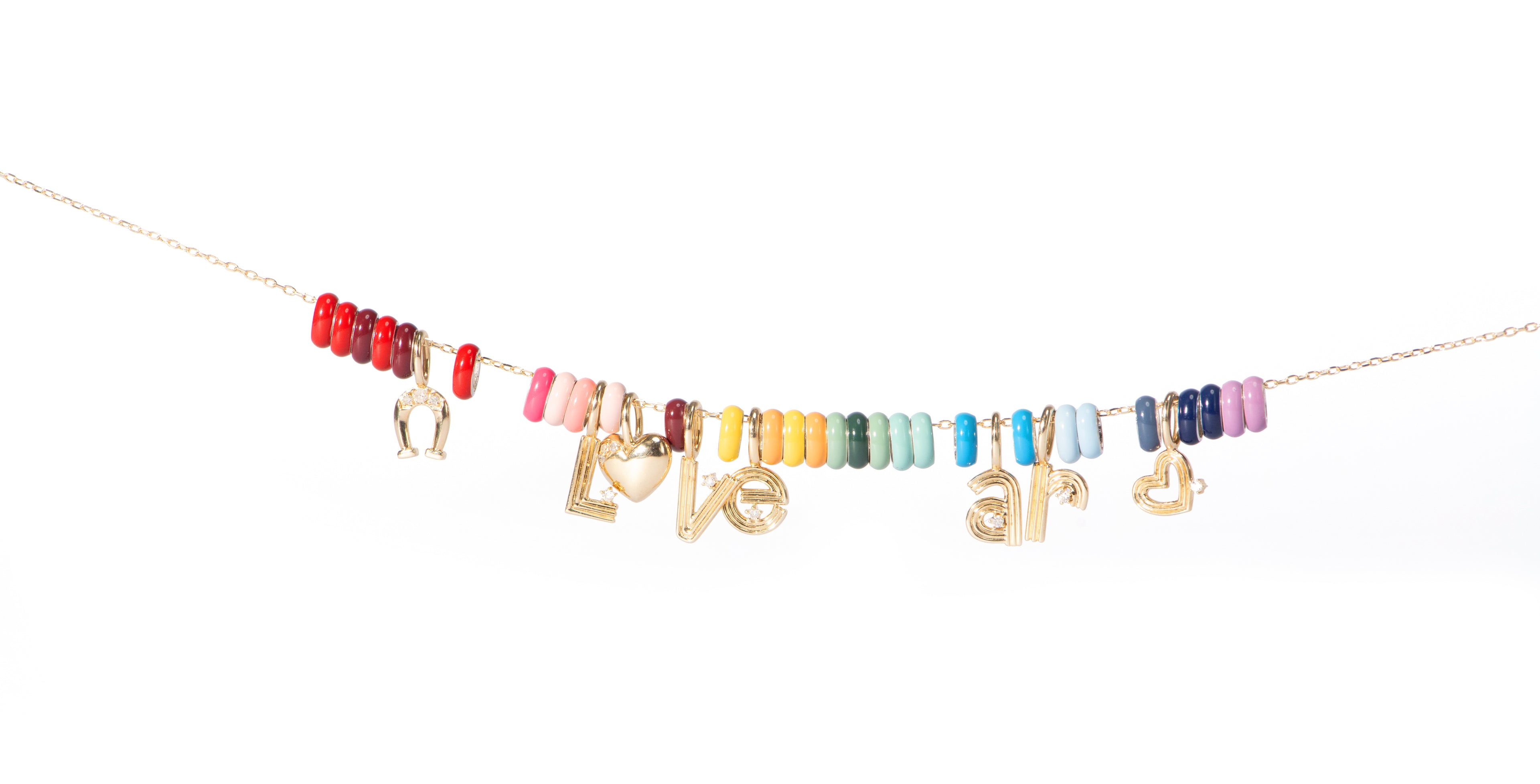 An Adina Reyter necklace with a variety of initial and colorful bead charms spelling "Love ar" against a white background