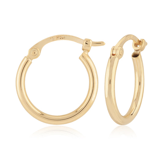 yellow gold hoop earrings against a white background