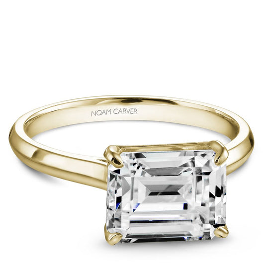 Noam Carver Yellow Gold Emerald East West Engagement Ring against a white background