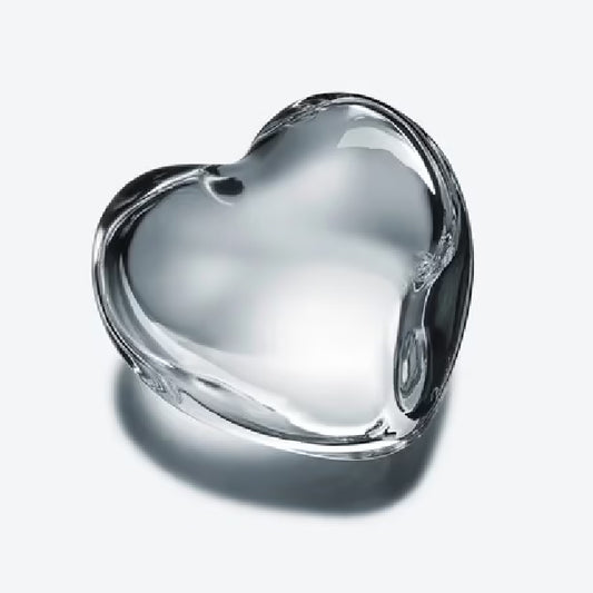 clear crystal heart-shaped paperweight against a white background
