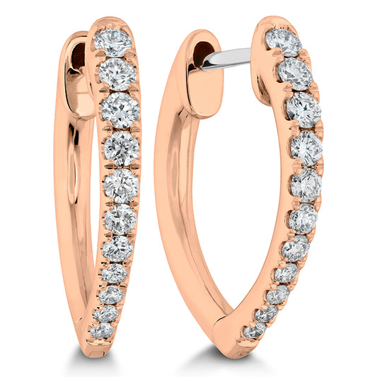 rose gold horseshoe-shaped diamond huggie earrings against a white background