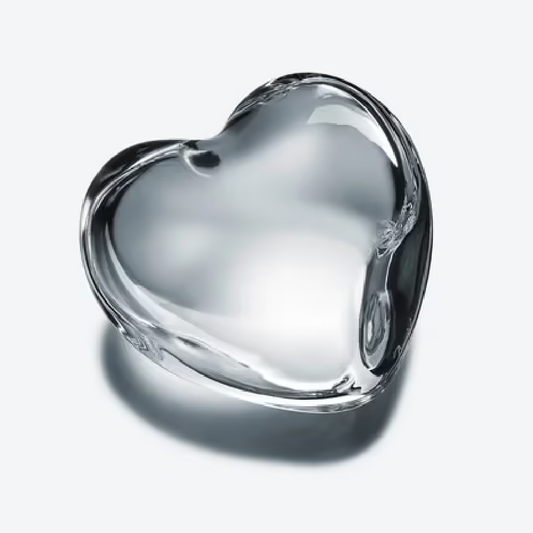 Clear crystal heart paperweight on white background
