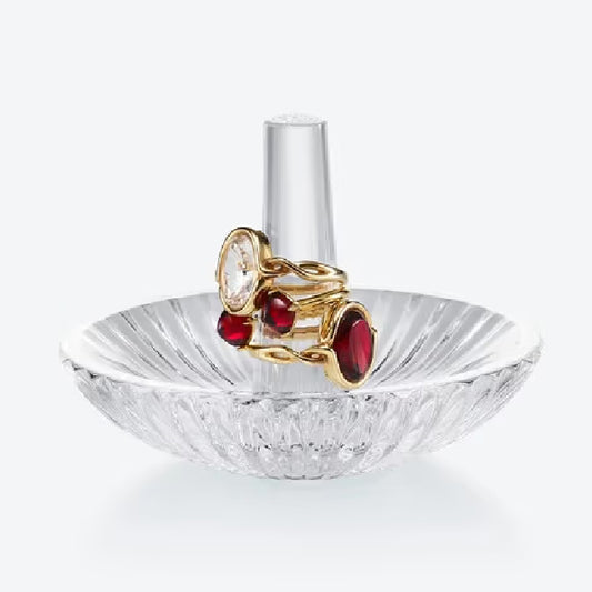 clear crystal Ring Holder with yellow gold ruby and diamond rings against a white background