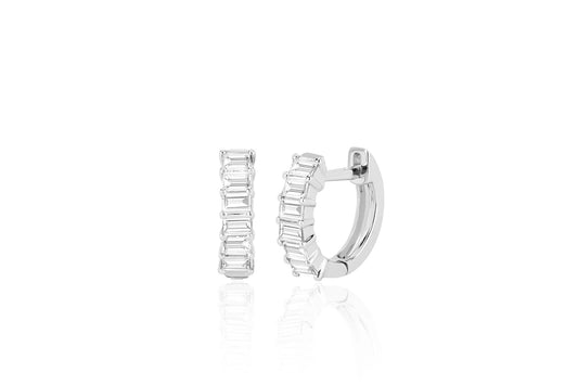 white gold Prong Set Diamond Baguette Huggie Earrings against a white background