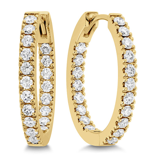 yellow gold oval hoop earrings with diamonds against a white background