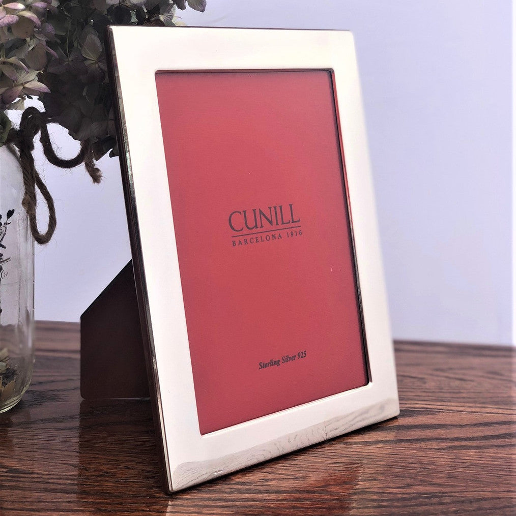 Silver frame placed on a wood table
