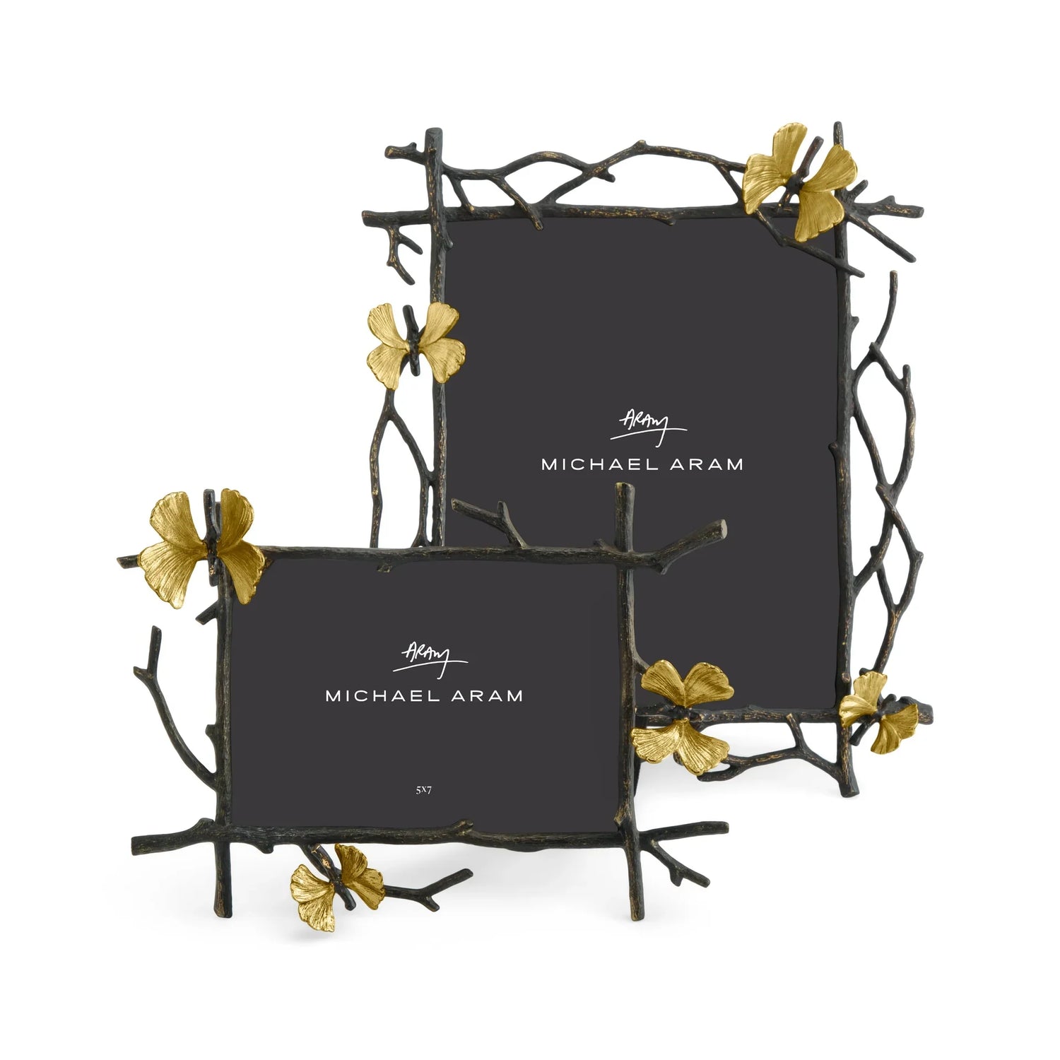 Two frames with detailing that looks like branches and butterflys on top of the branches