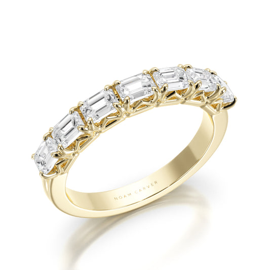 Noam Carver yellow gold wedding band with 7 emerald diamonds against a white background