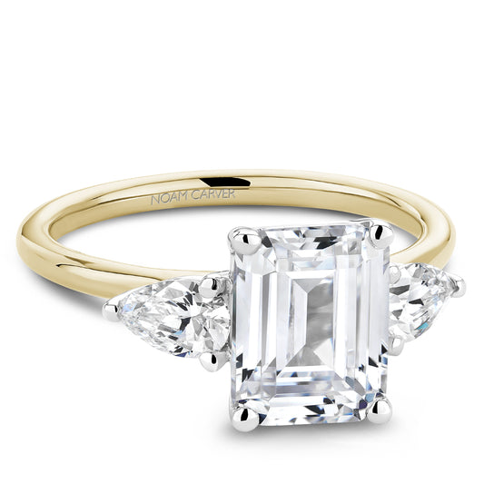 Noam Carver Yellow Gold Emerald Engagement Ring with White Gold Head and 2 Pear Diamond Side Stones against a white background