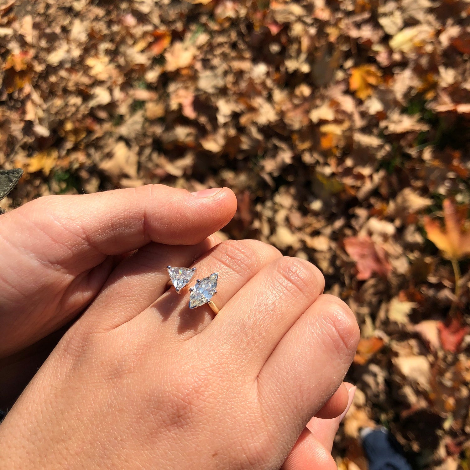 Close up of two people's hands, with one wearing a custom Holsten Jeweler's engagement ring. 