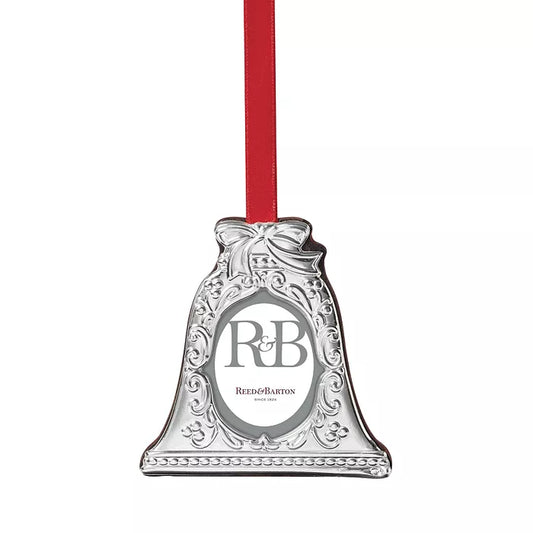 silver bell-shaped picture frame ornament with a red ribbon against a white background