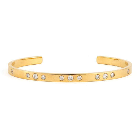 yellow gold Metal Set Diamond Cuff bracelet with Emerald Accents against a white background