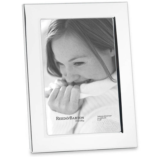 rectangular silver-plate picture frame set against a white background with black-and-white photo of a woman smiling into a white sweater