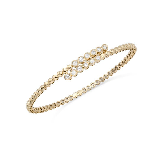 Flexible Yellow Gold & Diamond Bangle against a white background