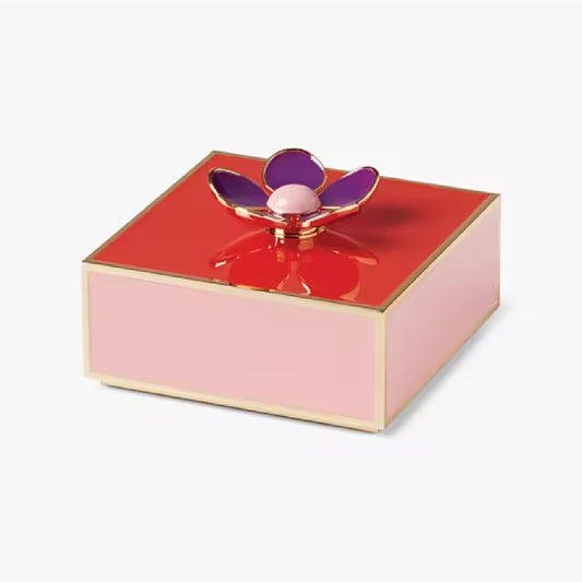 red and yellow gold jewelry box with a purple flower on the lid against a white background