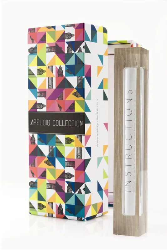 wood mezuzah beside a multi-colored box against a white background
