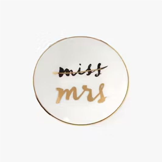 white miss to mrs. ring dish with a gold rim against a white background