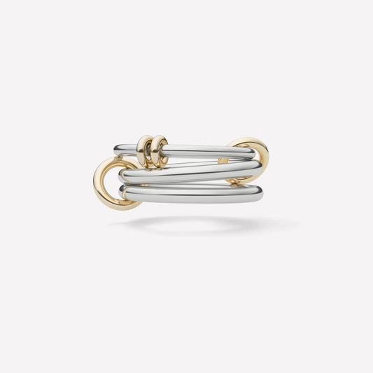 Ring stack with three white gold rings held together by smaller yellow gold rings and set against a white background