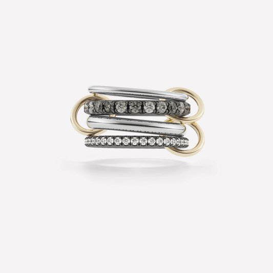 white gold ring stack with 4 rings containing diamonds of various sizes and three yellow gold rings holding the stack together. Ring stack is set against a white background