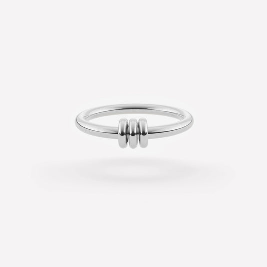 sterling silver ring with three smaller rings in the center against a white background
